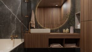 Renovated hotel bathroom featuring marble surfaces and contemporary fixtures